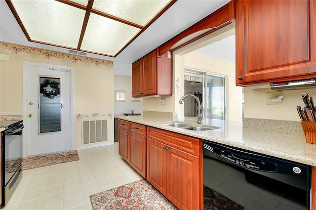810 Anchorage Ln, Palm Harbor, FL 34685 - kitchen with black appliances, a sink, light tile patterned flooring, light stone countertops, and a wainscoted wall