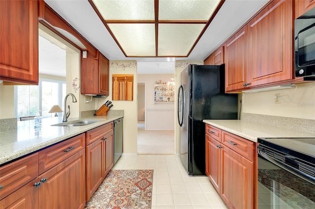 810 Anchorage Ln, Palm Harbor, FL 34685 - kitchen featuring black appliances, a sink, light stone countertops, light tile patterned floors, and brown cabinets