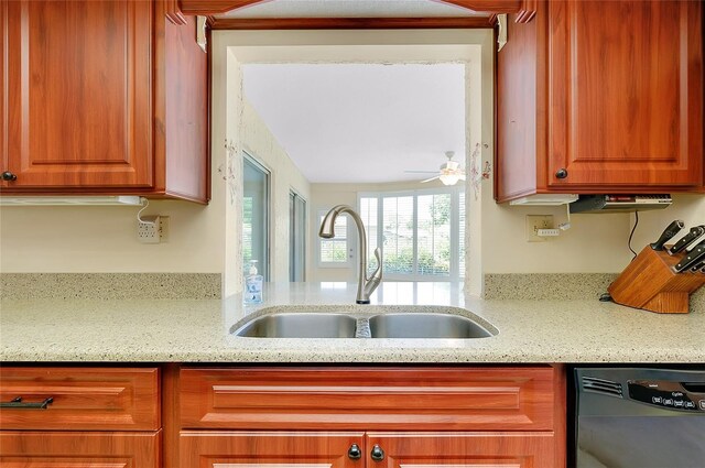 810 Anchorage Ln, Palm Harbor, FL 34685 - kitchen featuring black dishwasher, a sink, ceiling fan, and light stone countertops