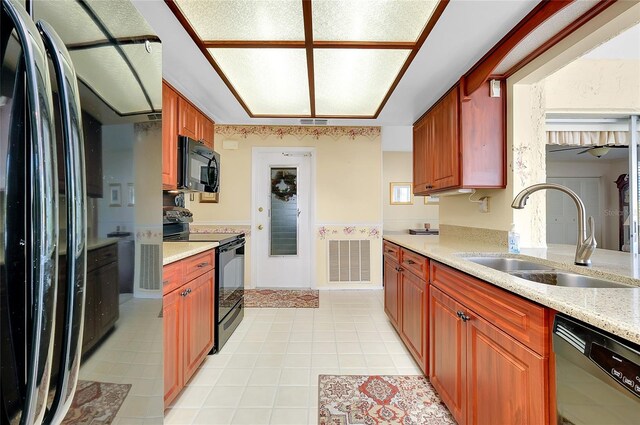 810 Anchorage Ln, Palm Harbor, FL 34685 - kitchen with black appliances, a sink, and light tile patterned flooring