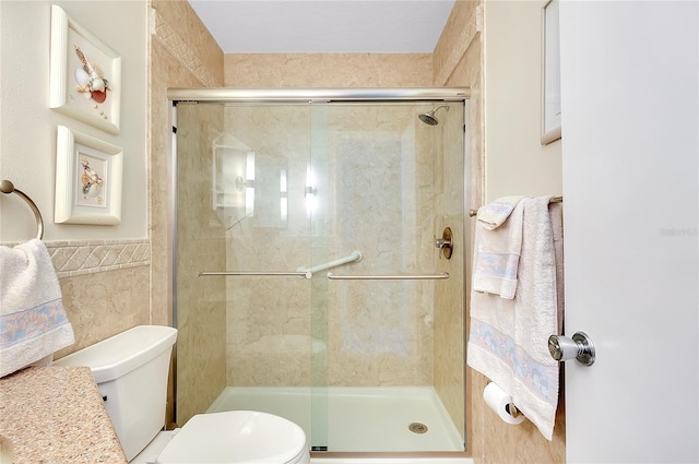 810 Anchorage Ln, Palm Harbor, FL 34685 - full bathroom with toilet, a stall shower, and tile walls