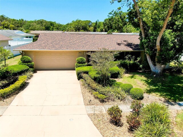 810 Anchorage Ln, Palm Harbor, FL 34685 - view of front of home with an attached garage, concrete driveway, and roof with shingles