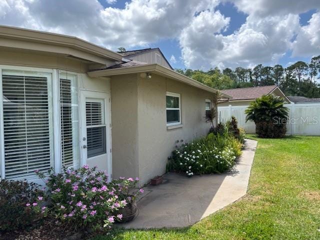 810 Anchorage Ln, Palm Harbor, FL 34685 - view of property exterior with stucco siding and a patio