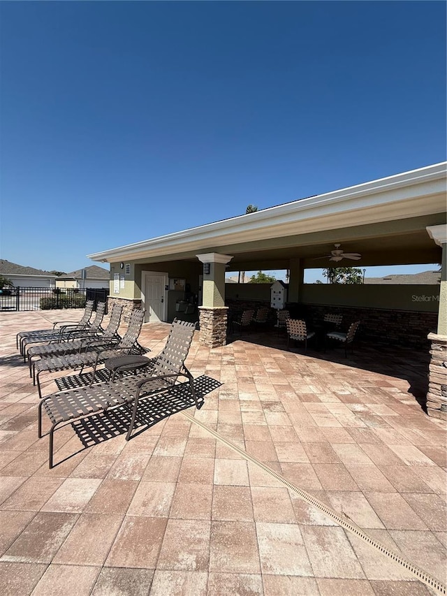 view of patio / terrace with fence and a ceiling fan