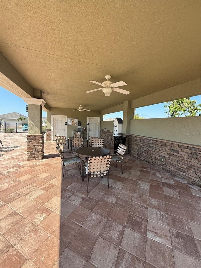 view of patio / terrace featuring fence and a ceiling fan