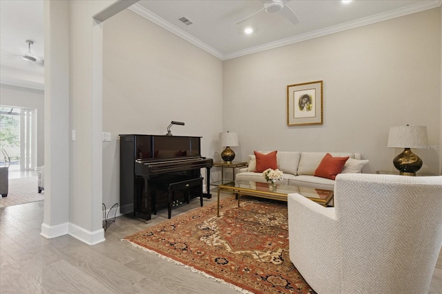 living room featuring crown molding, a ceiling fan, visible vents, recessed lighting, and baseboards
