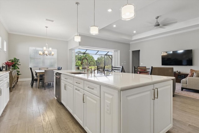 kitchen with a sink, light countertops, light wood-style flooring, and white cabinets