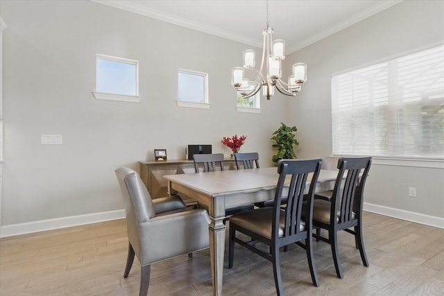dining area featuring light wood-style floors, an inviting chandelier, ornamental molding, and a wealth of natural light