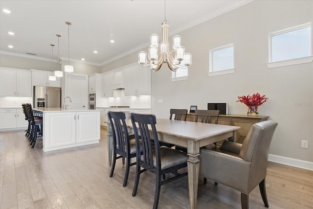 dining room featuring crown molding, light wood-type flooring, a chandelier, and recessed lighting
