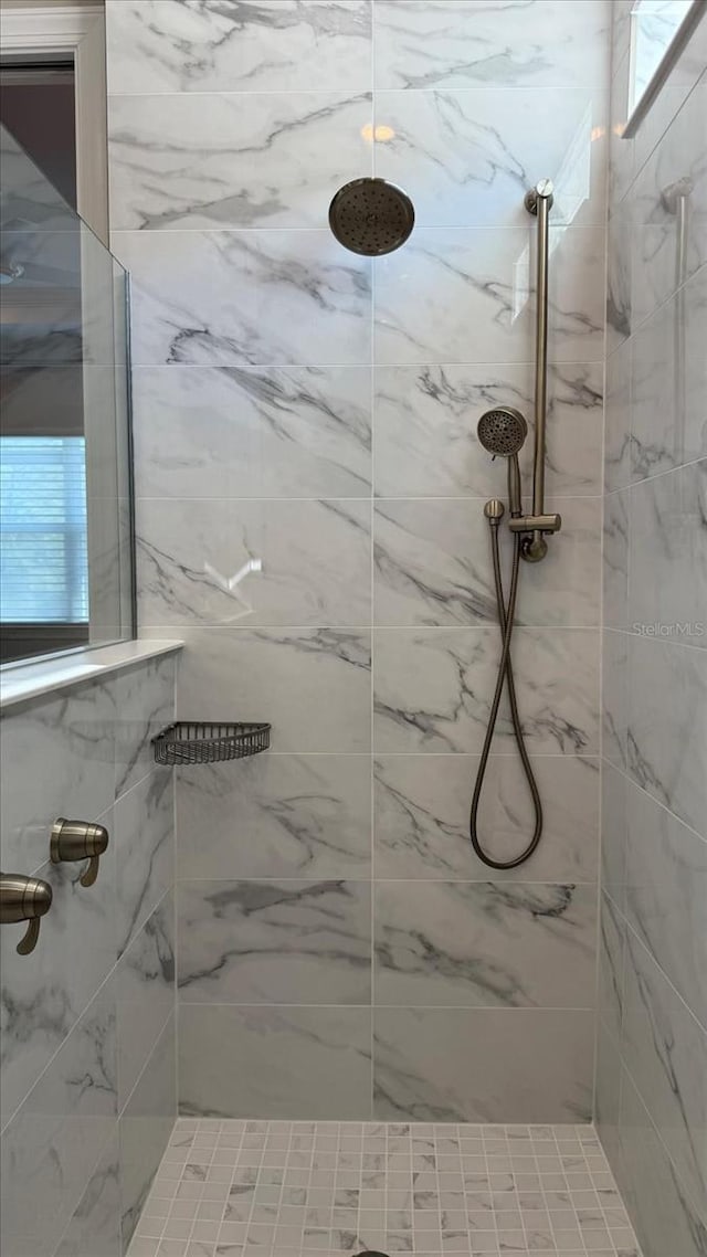 bathroom with a marble finish shower