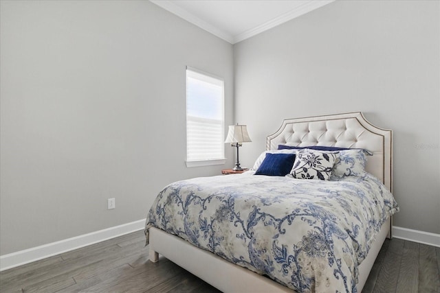 bedroom featuring crown molding, wood finished floors, and baseboards