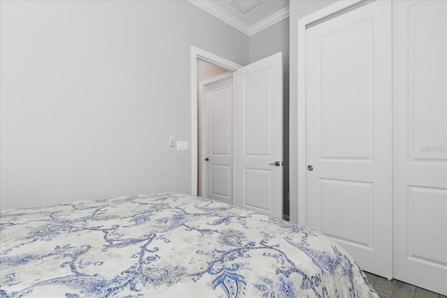 bedroom with ornamental molding and visible vents