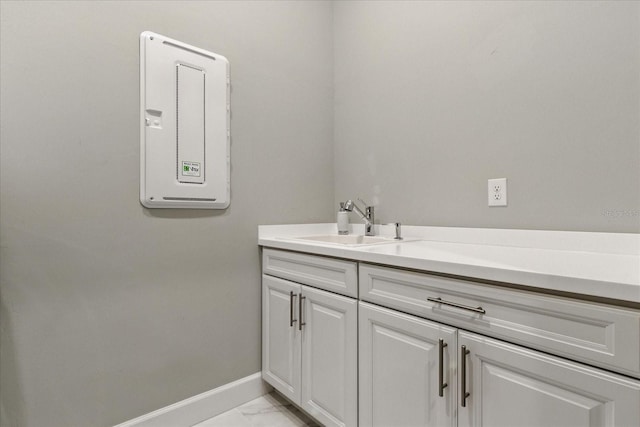 bathroom featuring marble finish floor, baseboards, and vanity