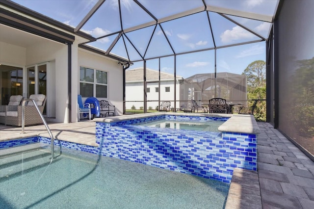 pool with a patio area, an in ground hot tub, and glass enclosure
