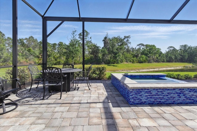 view of patio / terrace with a water view, an in ground hot tub, outdoor dining area, and a lanai