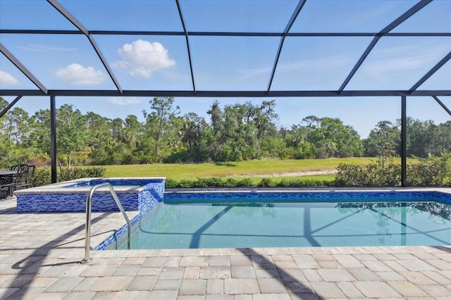 view of pool featuring a lanai, a patio, and a pool with connected hot tub
