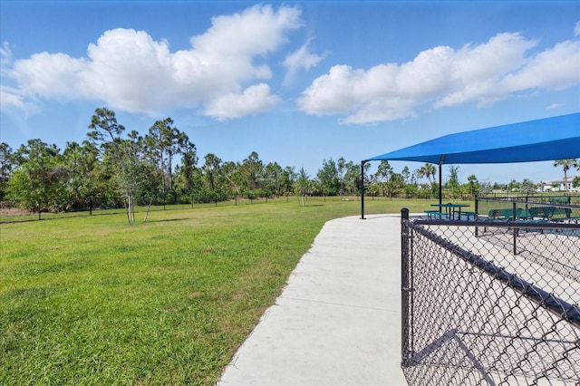 surrounding community featuring a yard and fence