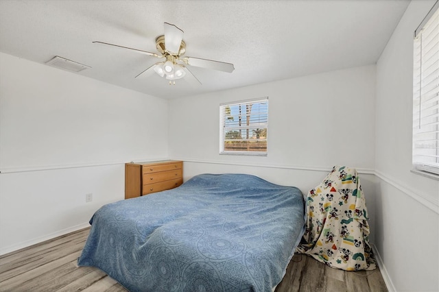 5755 Oxalis Rd, Venice, FL 34293 - bedroom featuring ceiling fan, baseboards, wood finished floors, and visible vents