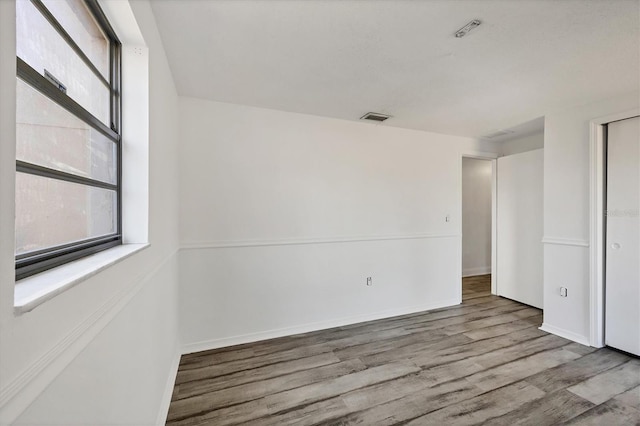 5755 Oxalis Rd, Venice, FL 34293 - unfurnished bedroom with baseboards, wood finished floors, and visible vents