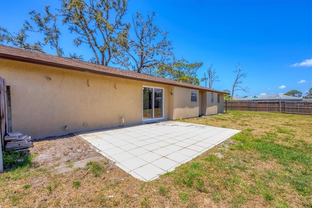 5755 Oxalis Rd, Venice, FL 34293 - rear view of house with fence, a patio, a yard, and stucco siding