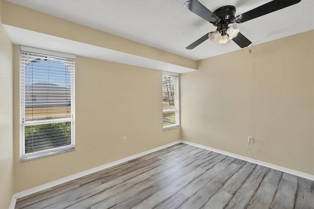 5755 Oxalis Rd, Venice, FL 34293 - spare room featuring a wealth of natural light, wood finished floors, and baseboards