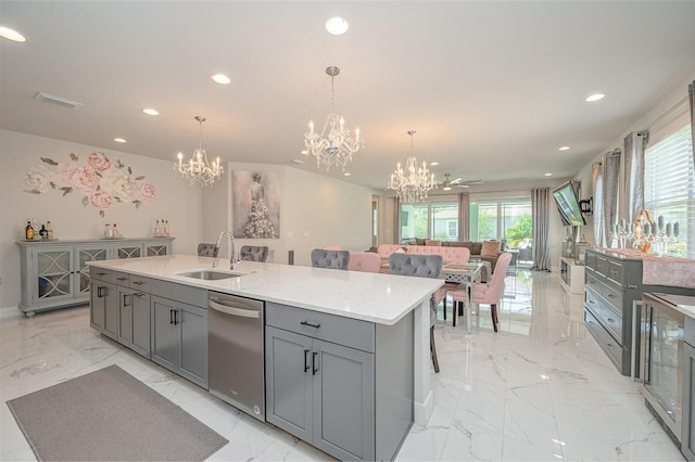 kitchen with stainless steel dishwasher, a notable chandelier, a sink, and gray cabinets