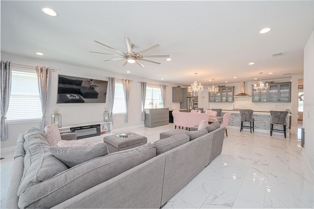 living room with recessed lighting, visible vents, marble finish floor, and ceiling fan with notable chandelier