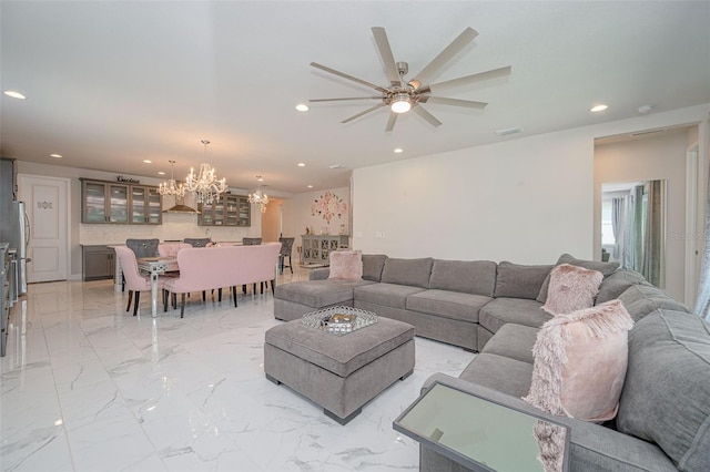 living room with recessed lighting, visible vents, ceiling fan with notable chandelier, and marble finish floor