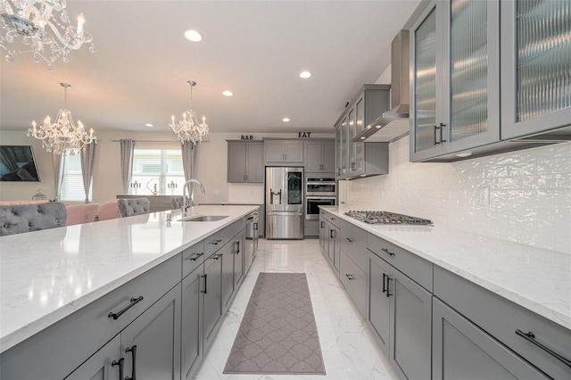 kitchen featuring gray cabinets, a chandelier, appliances with stainless steel finishes, marble finish floor, and a sink