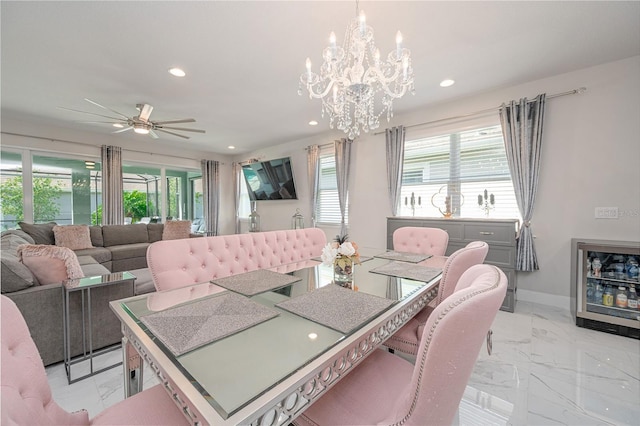 dining room featuring ceiling fan with notable chandelier, recessed lighting, marble finish floor, and a healthy amount of sunlight