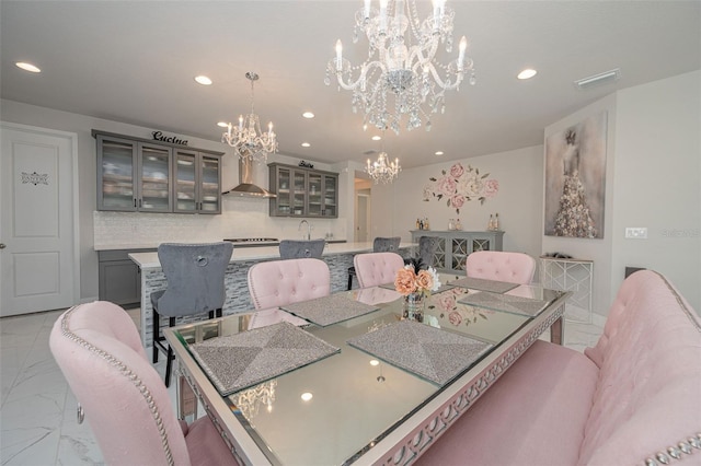 dining area featuring visible vents, recessed lighting, marble finish floor, and a notable chandelier