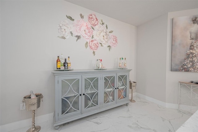interior space with marble finish floor and baseboards
