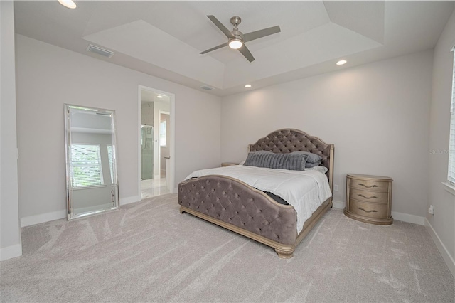 bedroom featuring a tray ceiling, carpet flooring, visible vents, and recessed lighting