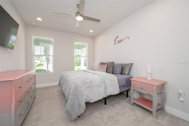 bedroom with baseboards, recessed lighting, and light colored carpet