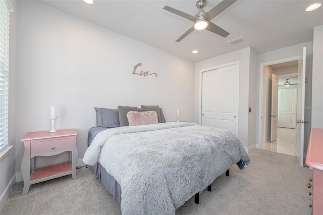 bedroom featuring a closet, recessed lighting, visible vents, and light colored carpet