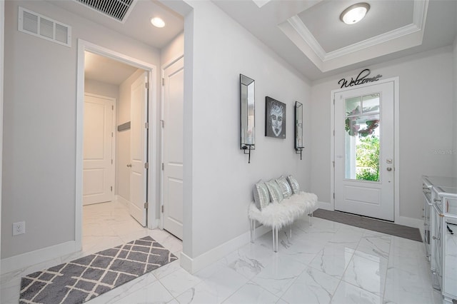 entryway with crown molding, visible vents, baseboards, and marble finish floor