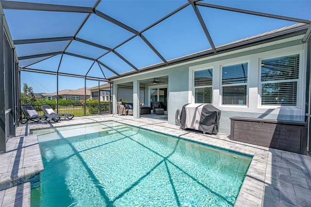 view of swimming pool with a patio, a lanai, a grill, and a ceiling fan