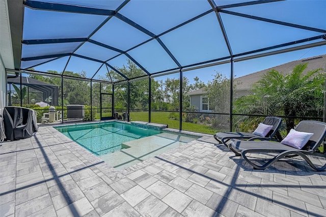 pool with a patio area and glass enclosure