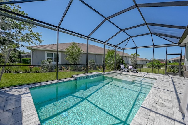 outdoor pool featuring a patio area, glass enclosure, and a lawn
