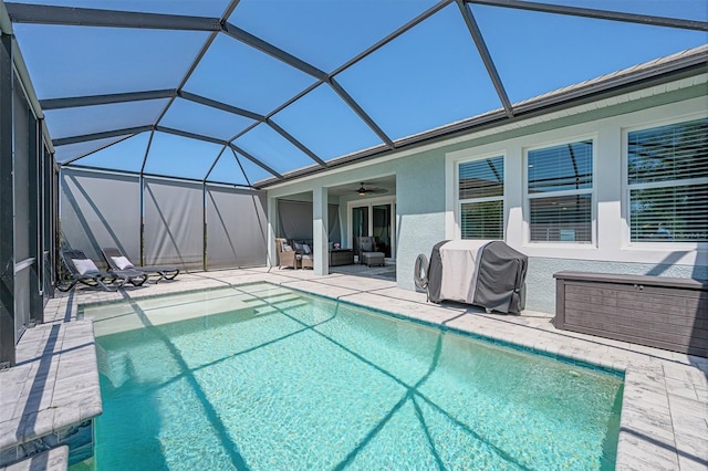 outdoor pool with a grill, outdoor lounge area, a ceiling fan, a patio, and a lanai