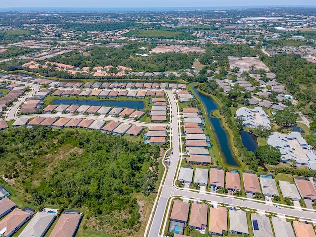 drone / aerial view with a water view and a residential view