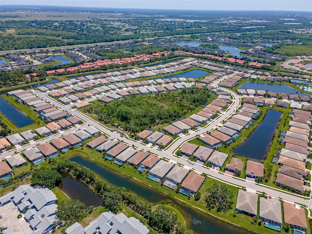 birds eye view of property with a residential view and a water view