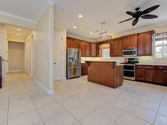 kitchen featuring a breakfast bar, light countertops, ornamental molding, and stainless steel appliances