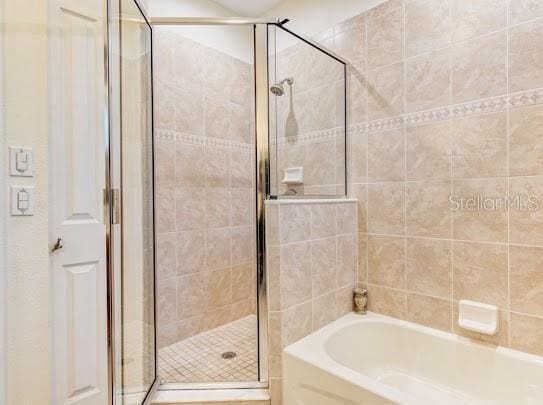 full bath with a garden tub and a stall shower