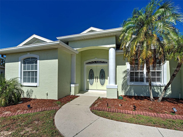 property entrance featuring stucco siding