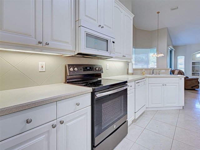 kitchen featuring white appliances, light tile patterned floors, light countertops, white cabinets, and a chandelier