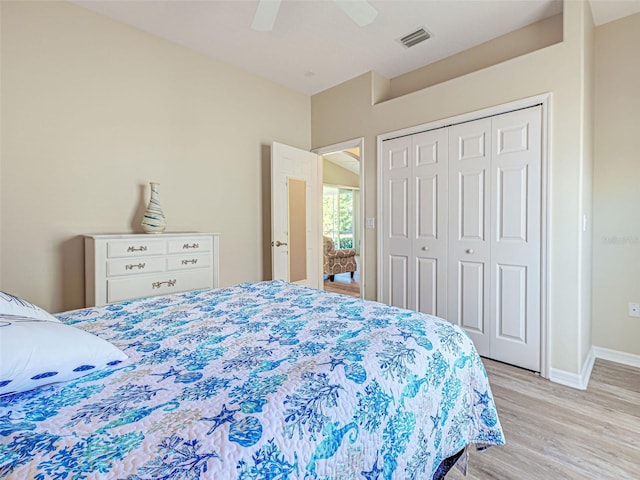 bedroom with light wood-type flooring, baseboards, a closet, and a ceiling fan