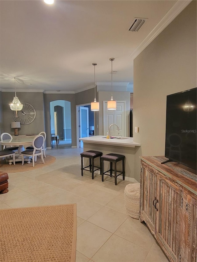 20188 Tesoro Dr, Venice, FL 34293 - living room with arched walkways, ornamental molding, and light tile patterned floors
