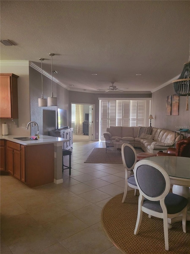 20188 Tesoro Dr, Venice, FL 34293 - living room with ornamental molding, light tile patterned flooring, ceiling fan, and a textured ceiling