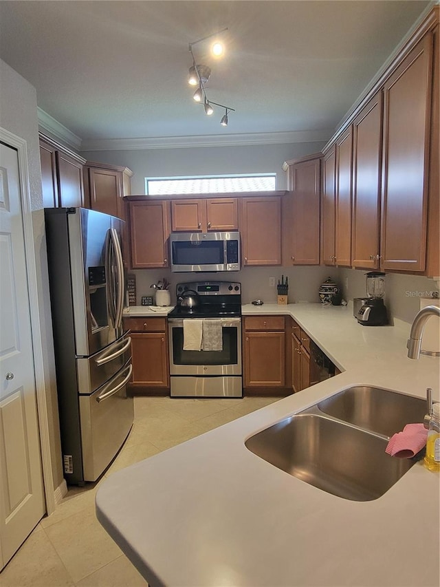 20188 Tesoro Dr, Venice, FL 34293 - kitchen featuring stainless steel appliances, light countertops, crown molding, light tile patterned floors, and track lighting